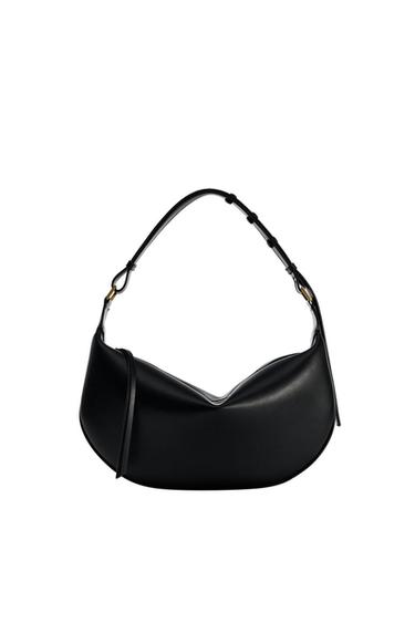 Black curved design handbag with an adjustable strap and gold metallic details, on a white background.