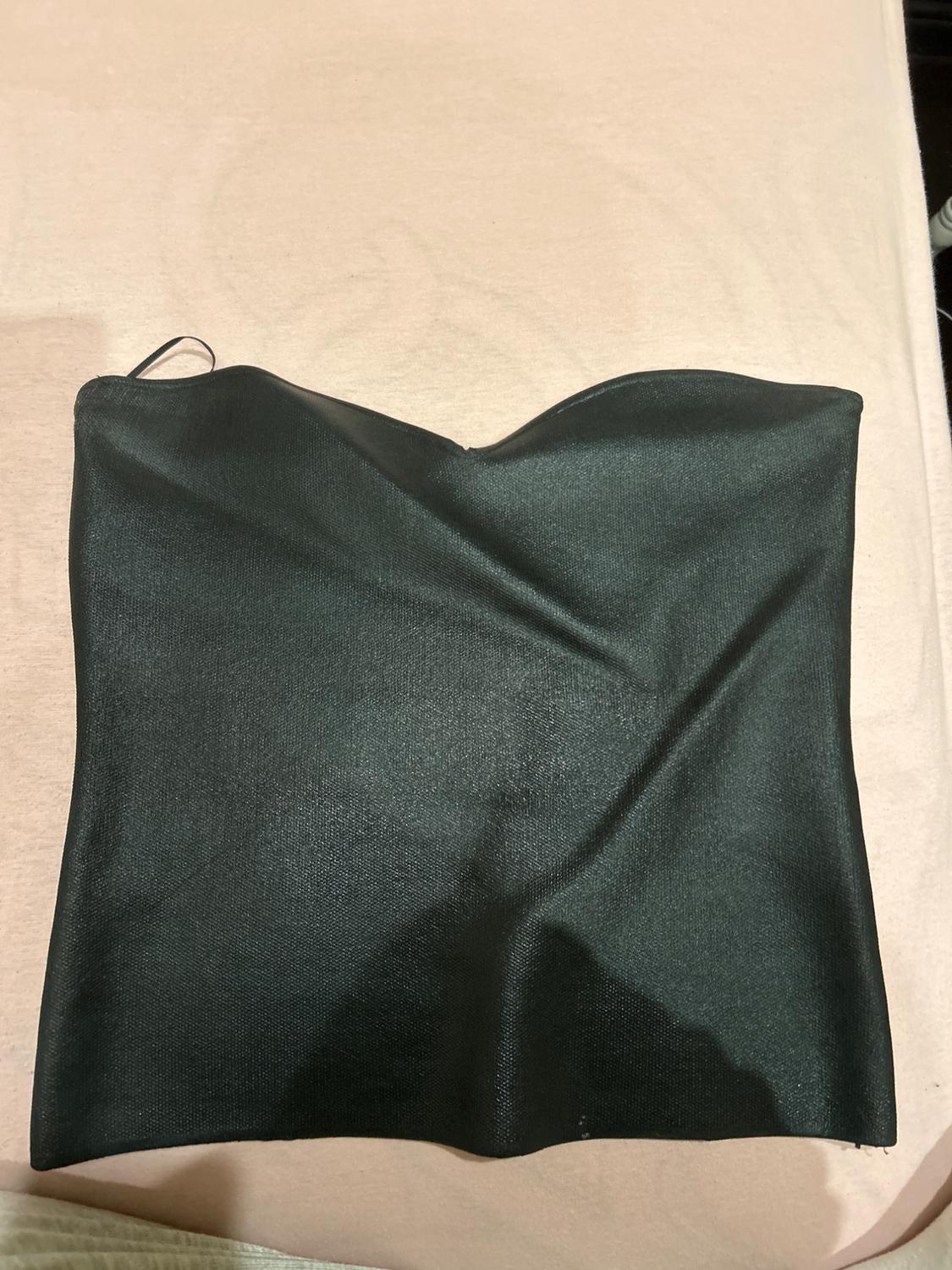 Front view of a black strapless top with a sweetheart neckline.