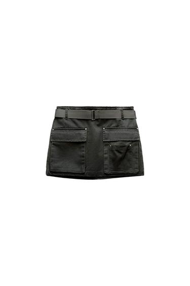 Black mini skirt with a belt and two large front pockets. White background.