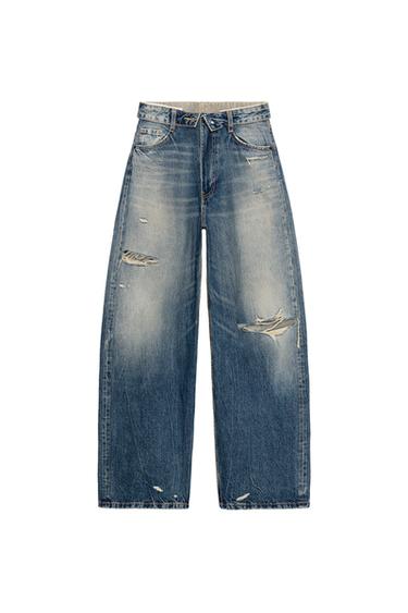 Front view of navy blue ripped jeans, mid-rise, folded waistband, five pockets and front zip and button fastening.