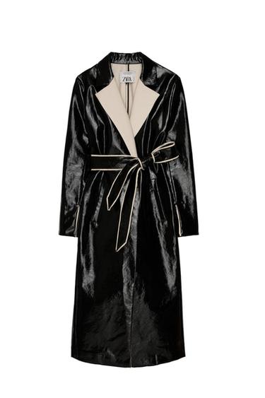 Shiny black coat with beige lapels and a matching belt. Visible label with the text "ZARA" on the inside of the collar.