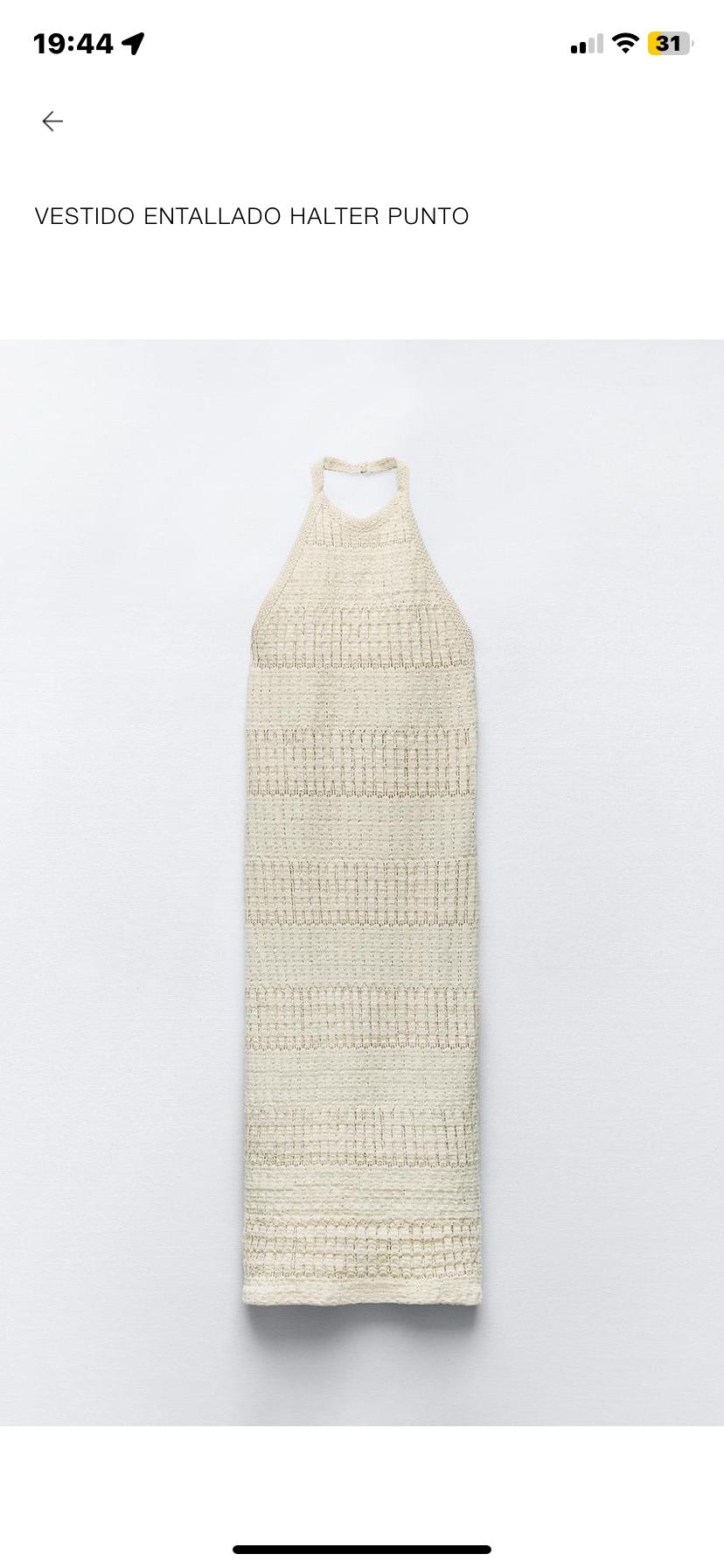 Front view of a cream-coloured knitted halter-neck fitted dress.