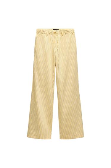 Front view of striped yellow pants with elastic waistband and drawstring.