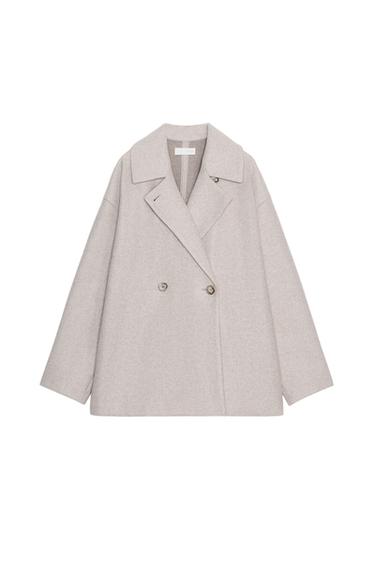 Front view of a light beige, short coat with a lapel collar, long sleeves, and a double-breasted button fastening.