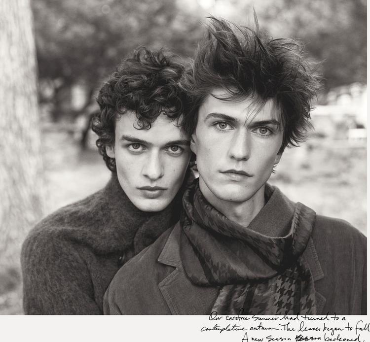 Black and white photo of two models with curly, dishevelled hair, wearing coats and scarves. Text: "Our active summer had turned to a contemplative autumn."