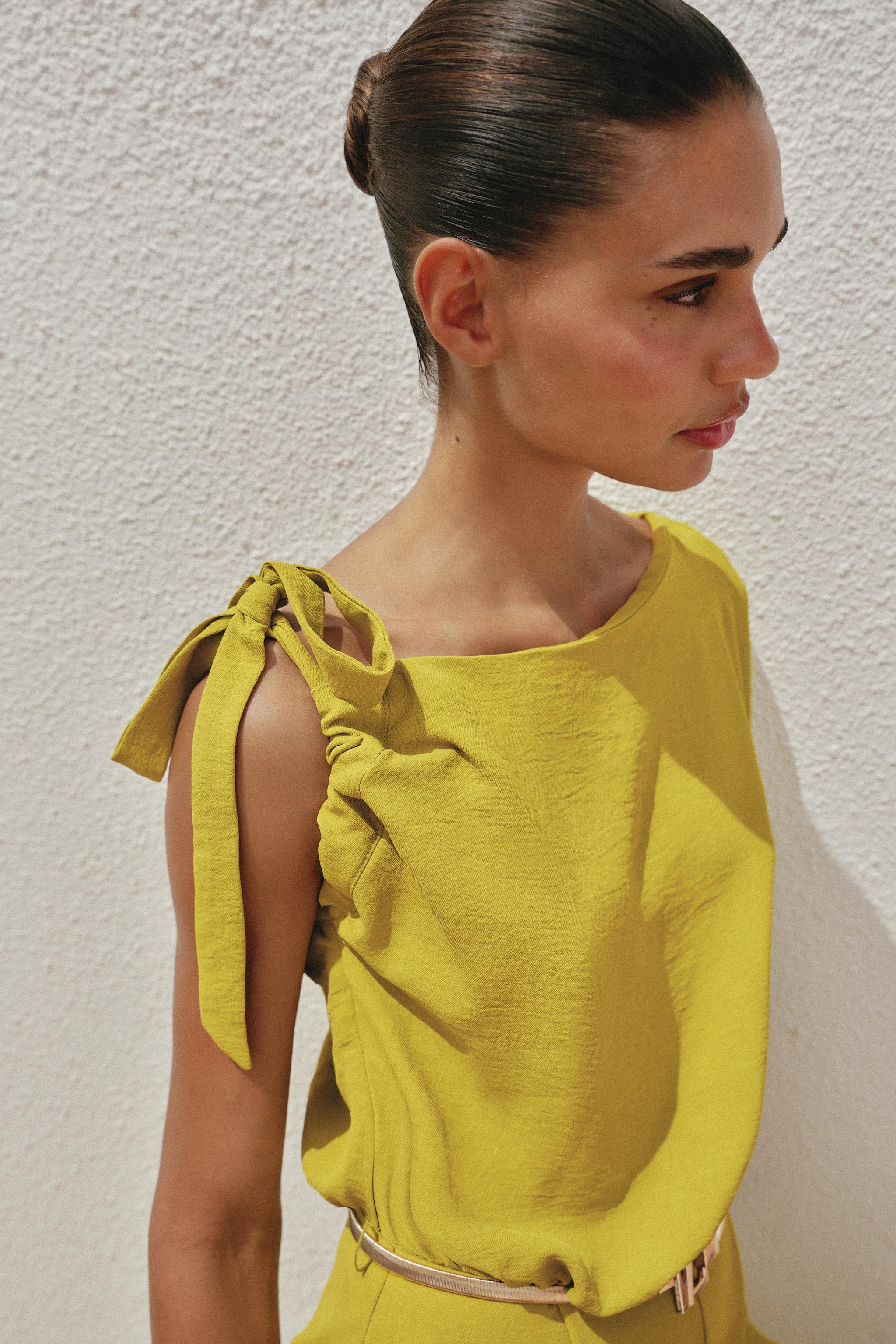ASYMMETRIC SLEEVE BELTED JUMPSUIT