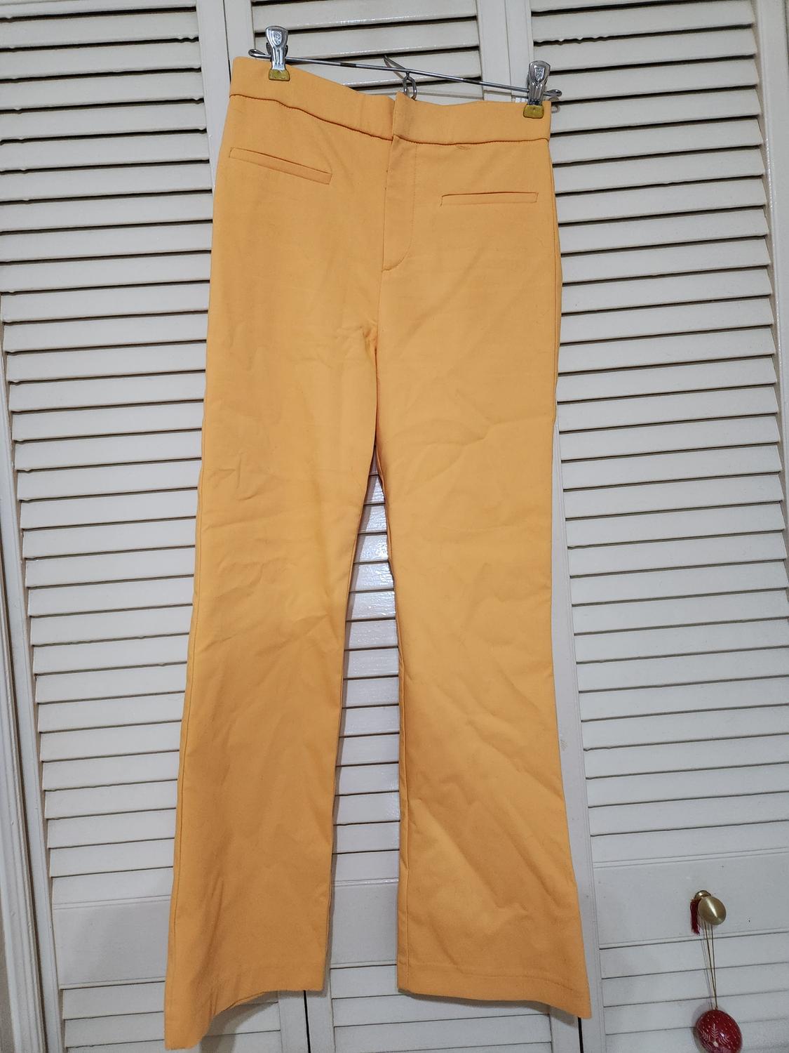 Front view of yellow pants with back pockets.