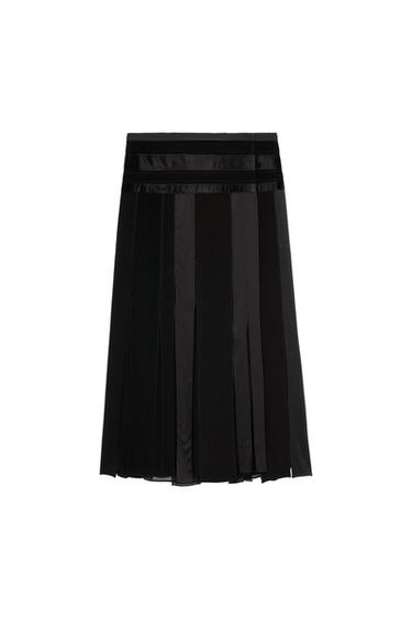Black pleated skirt with horizontal bands at the waist and vertical panels of shiny fabric on a white background.