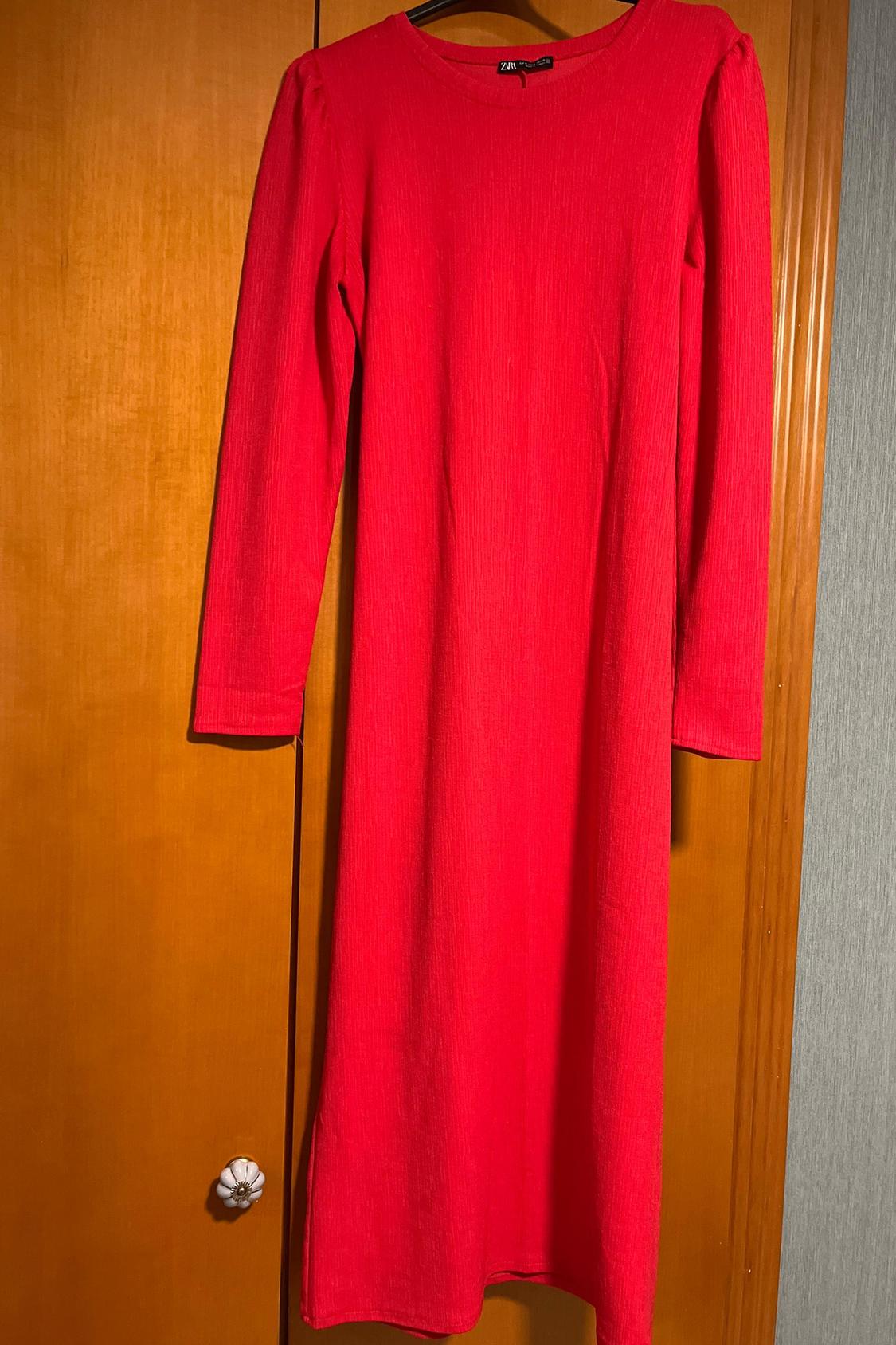 Front view of a long-sleeved red dress with a round neck.