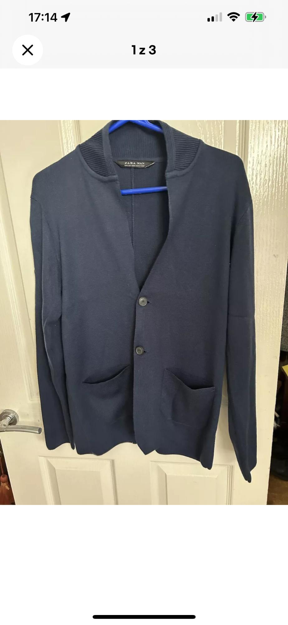 Front view of a navy blue jacket with lapel and front pockets.