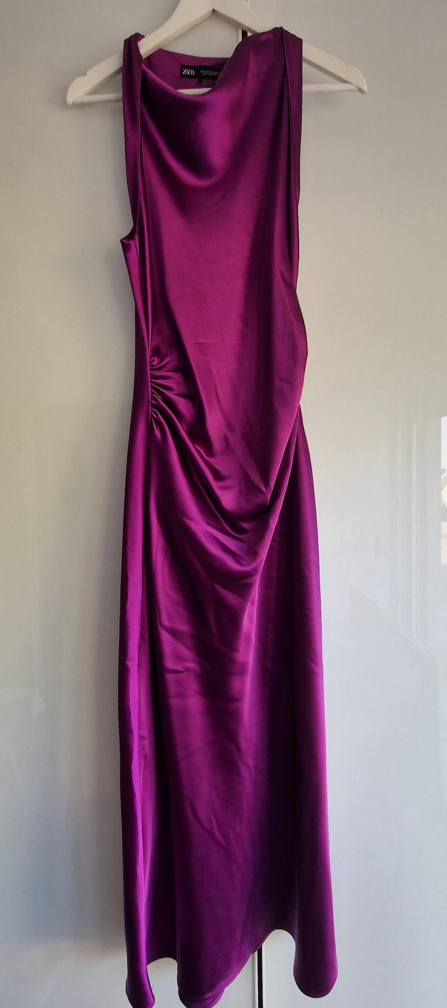 Long purple satin sleeveless dress on a white hanger against a light background. It features a fluid neckline, side ruching and a ZARA label.