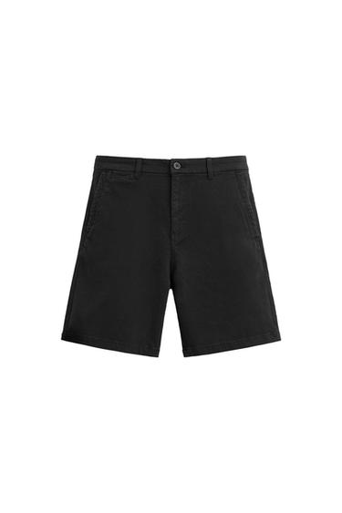 Black cotton shorts with side pockets and button fastening, presented on a white background.