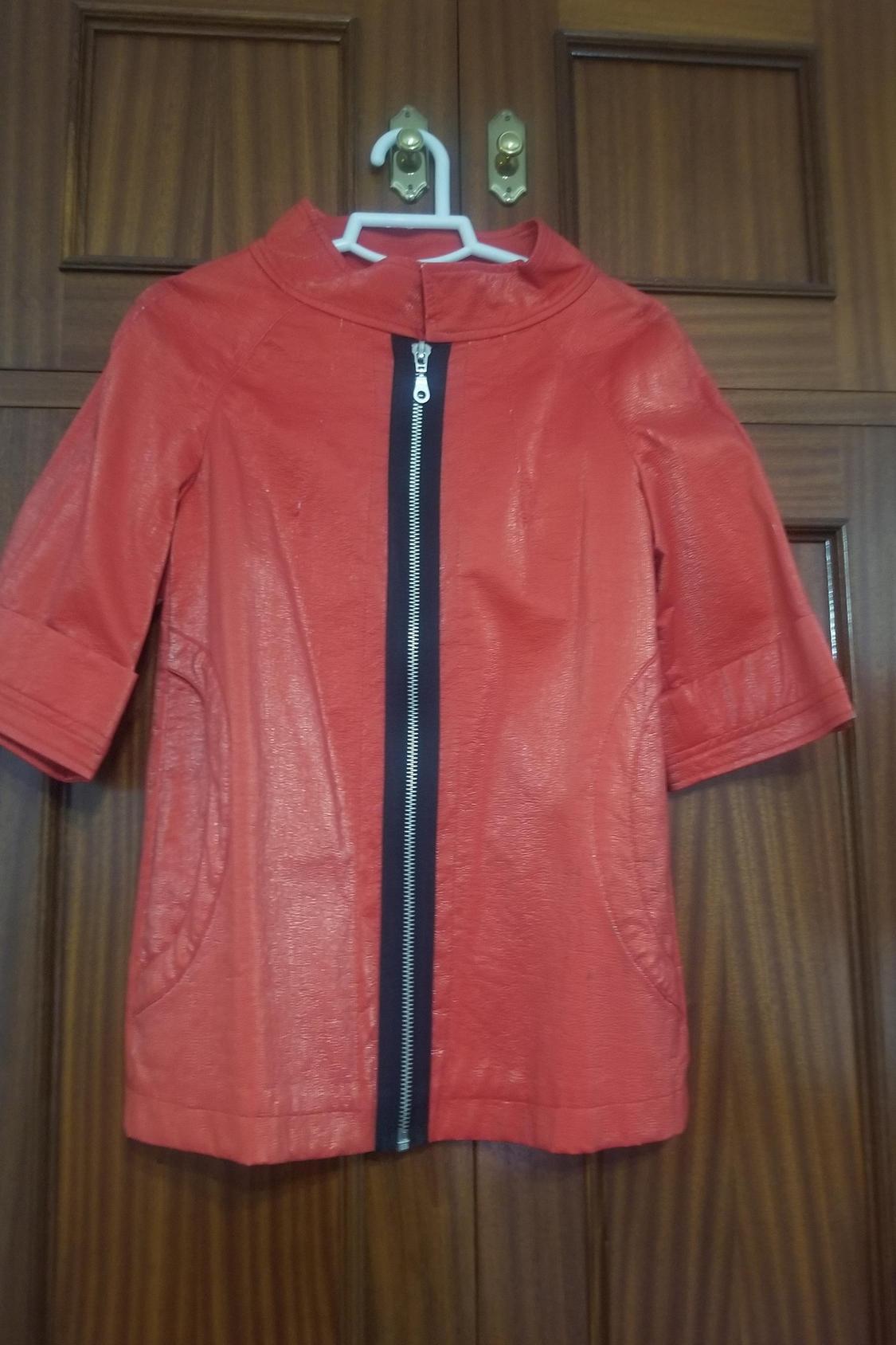 Front view of red jacket with front zip and side pockets.