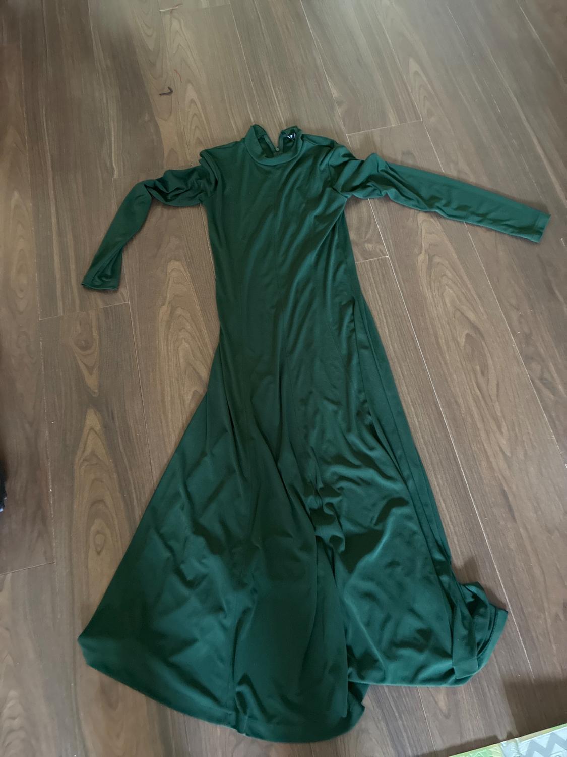 Dark green, long-sleeved, high-neck maxi dress, laid out on a wooden floor.
