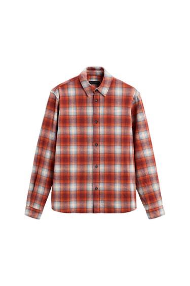 Checked shirt in red, blue, and white tones, with dark buttons and a classic collar, on a white background.