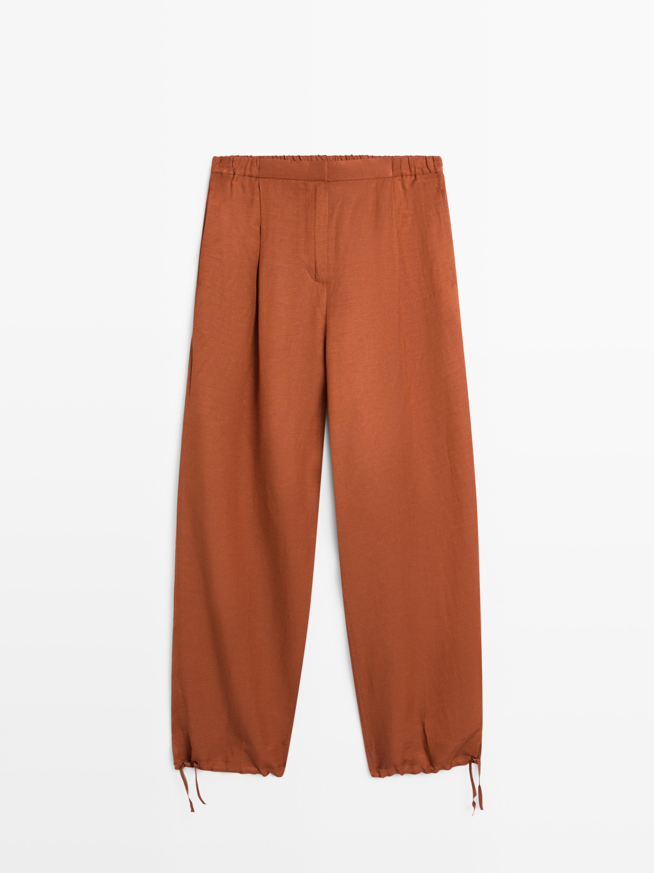 Flowing trousers with tie detail — Orange