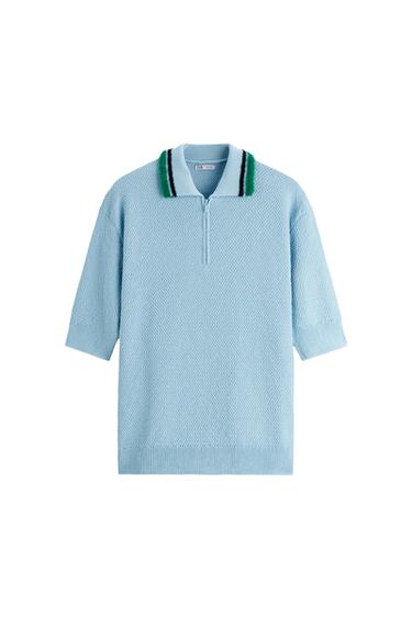 Light blue short-sleeved knitted polo shirt with a half-zip. Collar with green and black stripes. ZARA label. White background.
