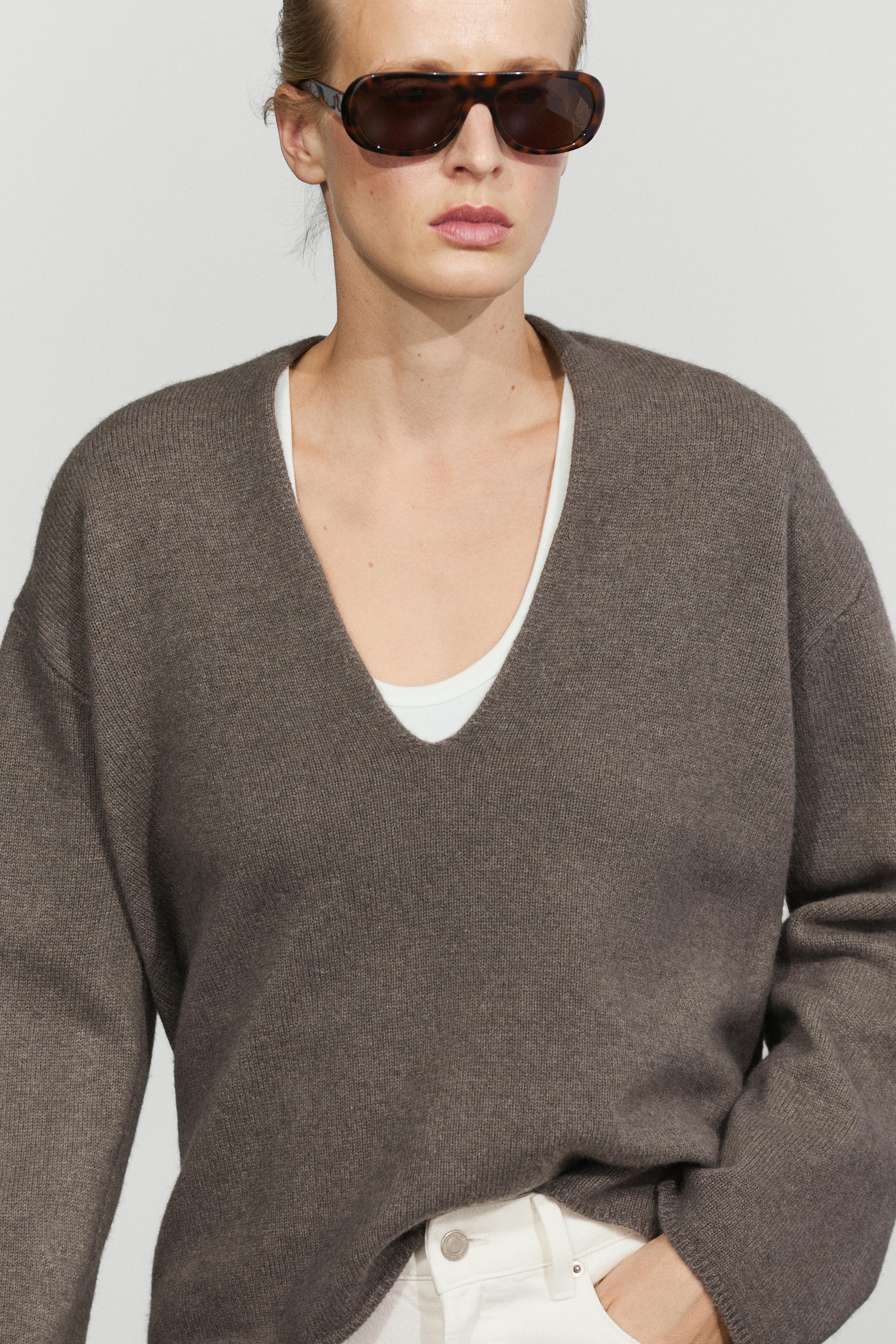 Long-line knit sweater with neckline detail