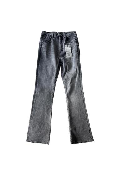 Front view of gray jeans with front pockets and visible tag.