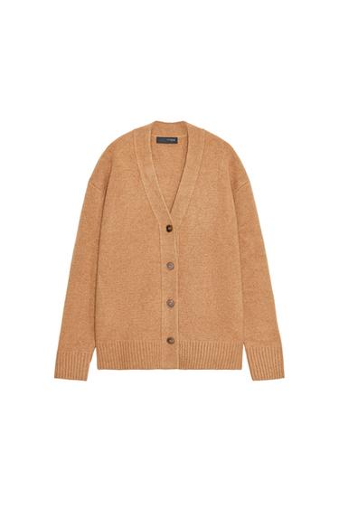 Front view of a dark camel oversized jacket with a V-neck, long sleeves, and a front button fastening. Ribbed trims.