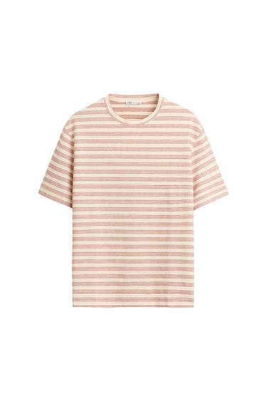 Horizontal striped T-shirt in beige and light pink tones, with a round neck and short sleeves, on a white background.