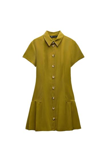 Short olive green short-sleeved dress with a shirt collar. Front button fastening and pleated hem. White background. ZARA text.