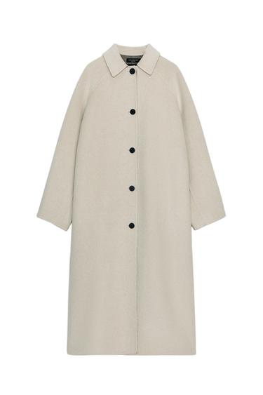 Front view of a long, coat with a lapel collar, long sleeves, and a front black button closure. Hidden side pockets.