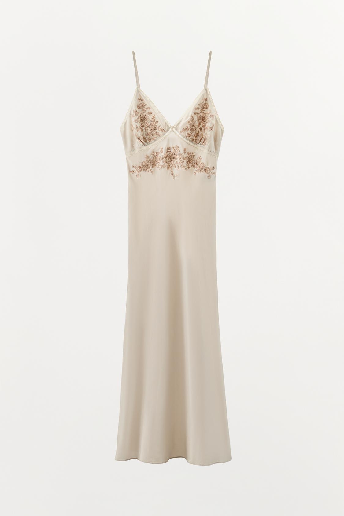 Front view of a greenish slip dress with a V-neck, thin straps, and floral bead embroidery on the chest.
