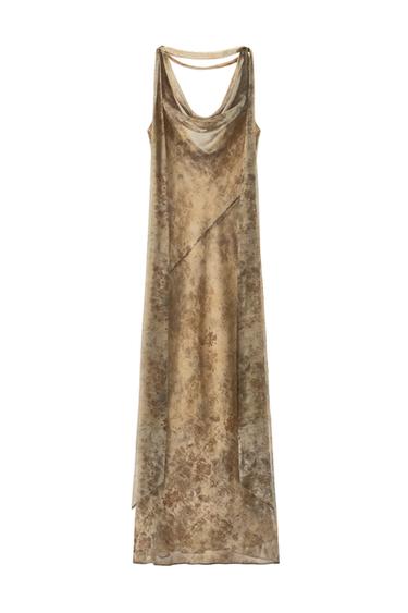 Front view of a beige long dress with a floral print, cowl neckline and straps.
