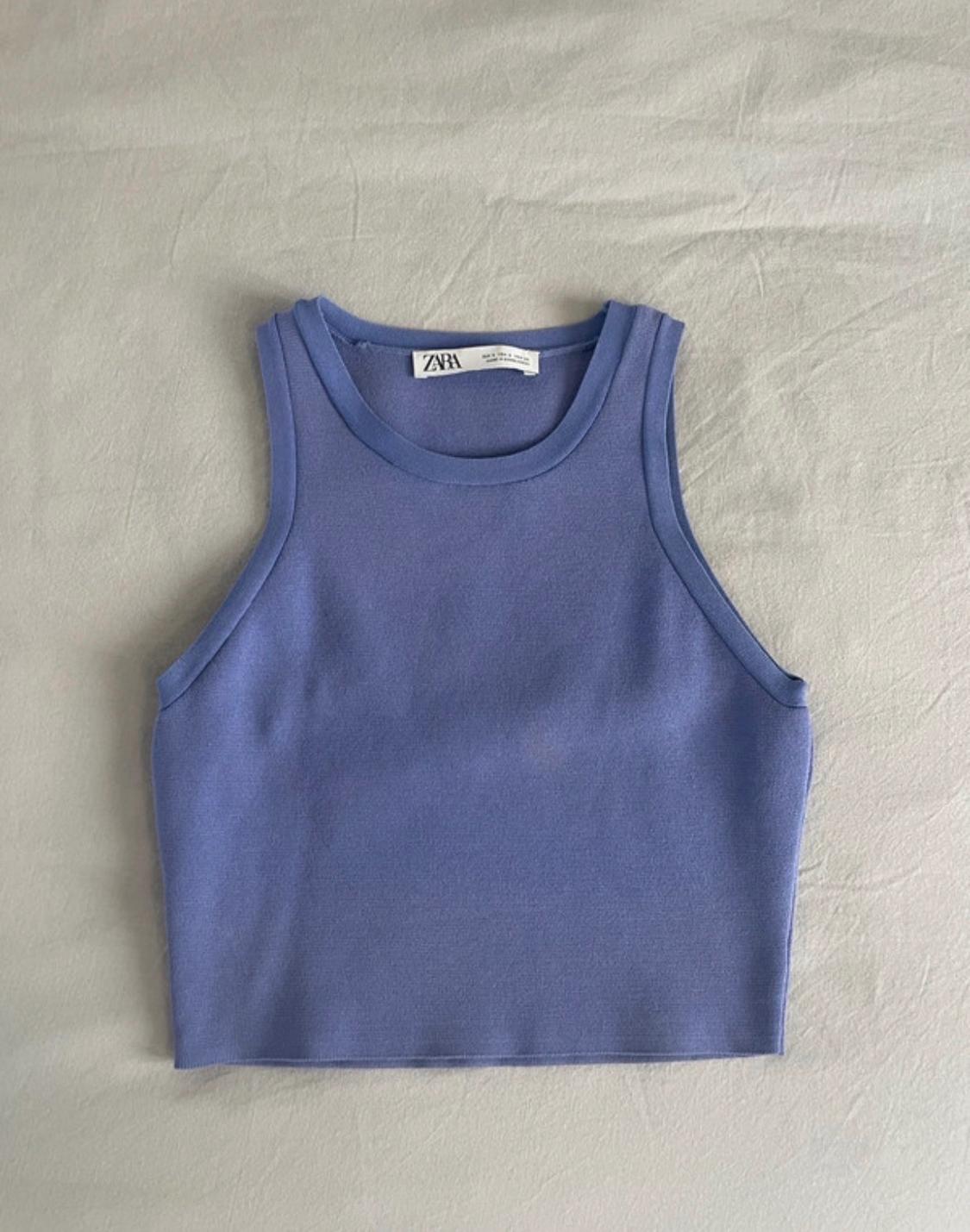Cropped sleeveless top in lavender blue on a light-coloured fabric surface. Label with the text ZARA.