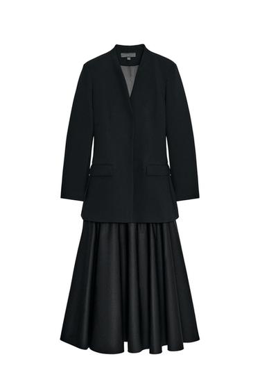 Front view of black blazer dress with V-neckline, long sleeves and flap pockets. Midi skirt in a combined fabric.