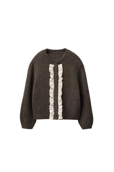 Front view of a taupe brown jacket with a round neck, long sleeves and button fastening with lace detailing on the front.