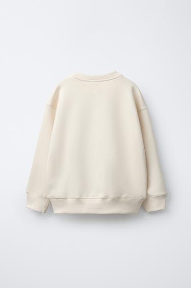 SWEAT À INSCRIPTION FLOQUÉE - Écru de Zara - Image 1