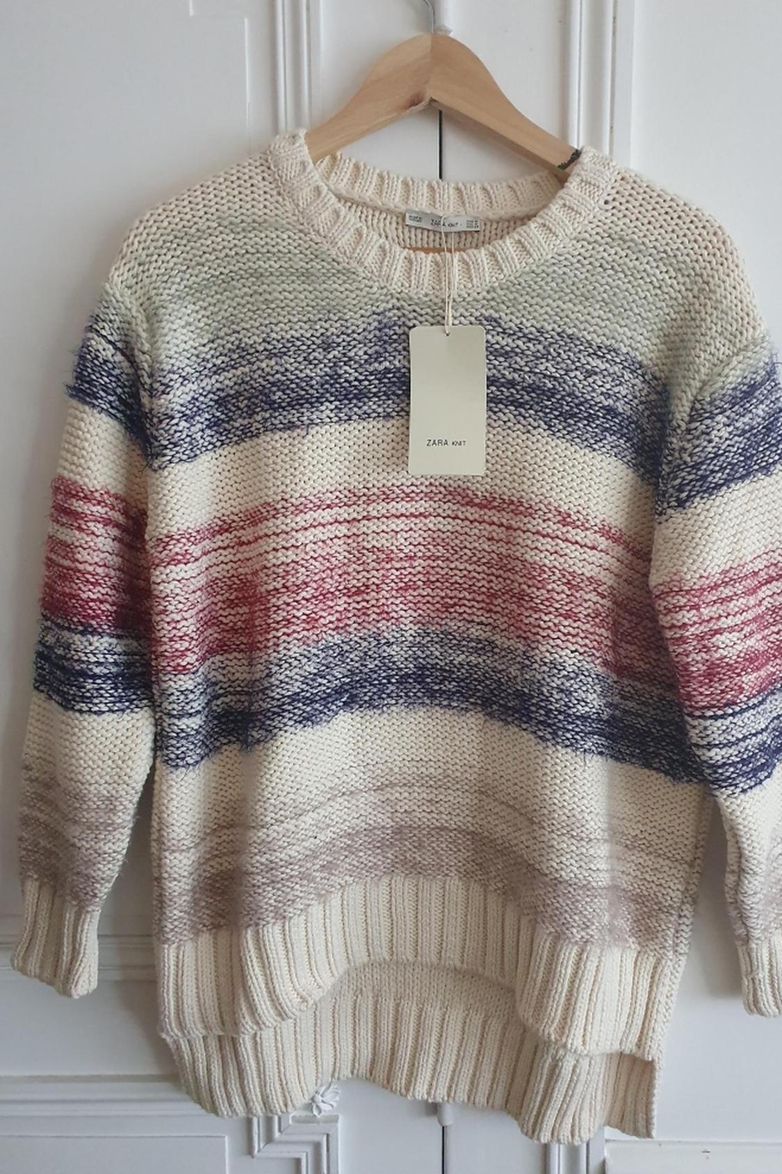 Front view of multi-coloured striped knitted jumper with 'ZARA Knit' label.