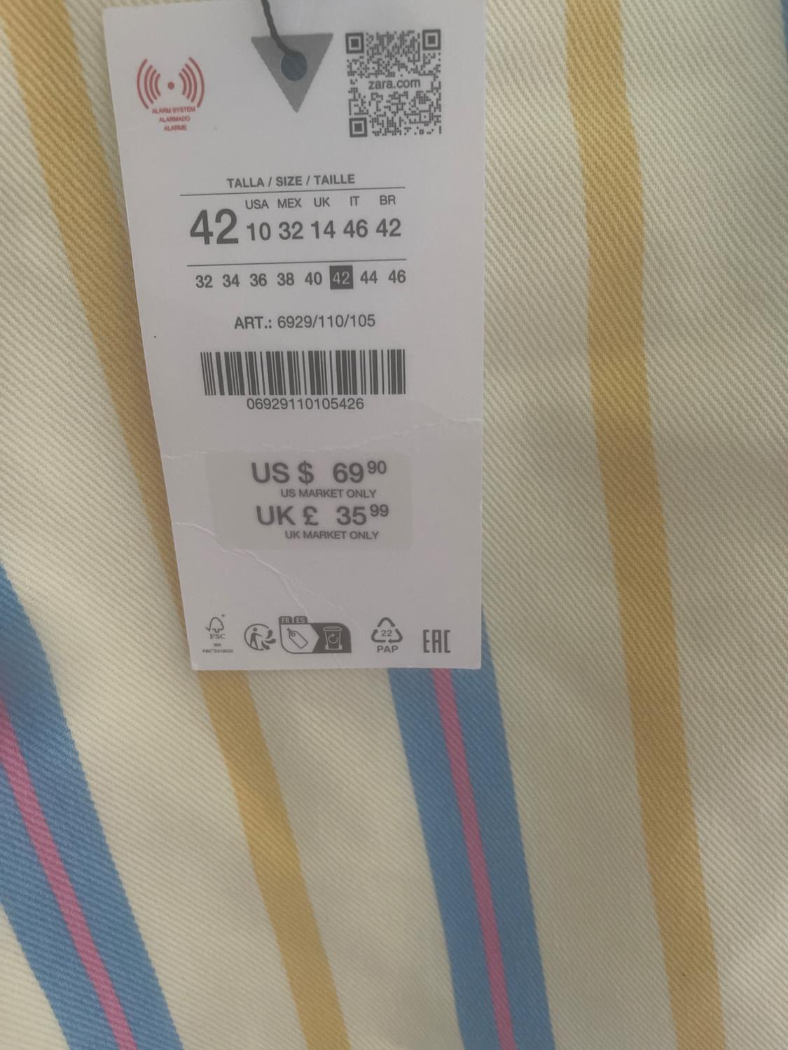 Label on striped fabric. Text: zara.com SIZE 42 USA 10 MEX 32 UK 14 IT 46 BR 42 ART.: 6929/110/105 US $ 69.90 UK £ 35.99
