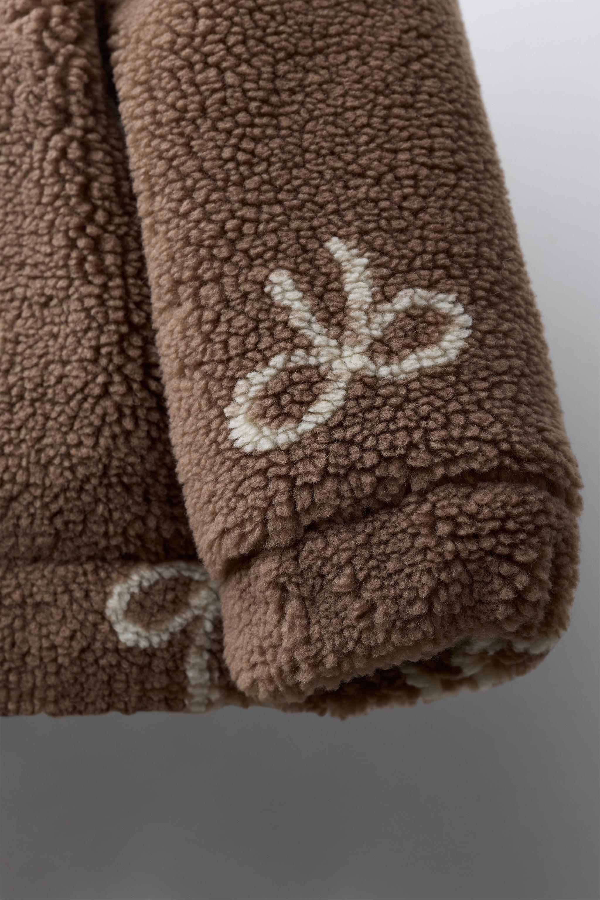 FAUX SHEARLING JACKET WITH BOW PRINT