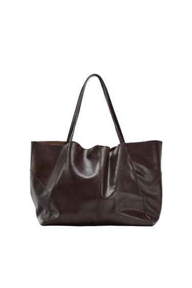 Minimalist-style tote bag in dark brown with two long handles and a panelled design on a white background.