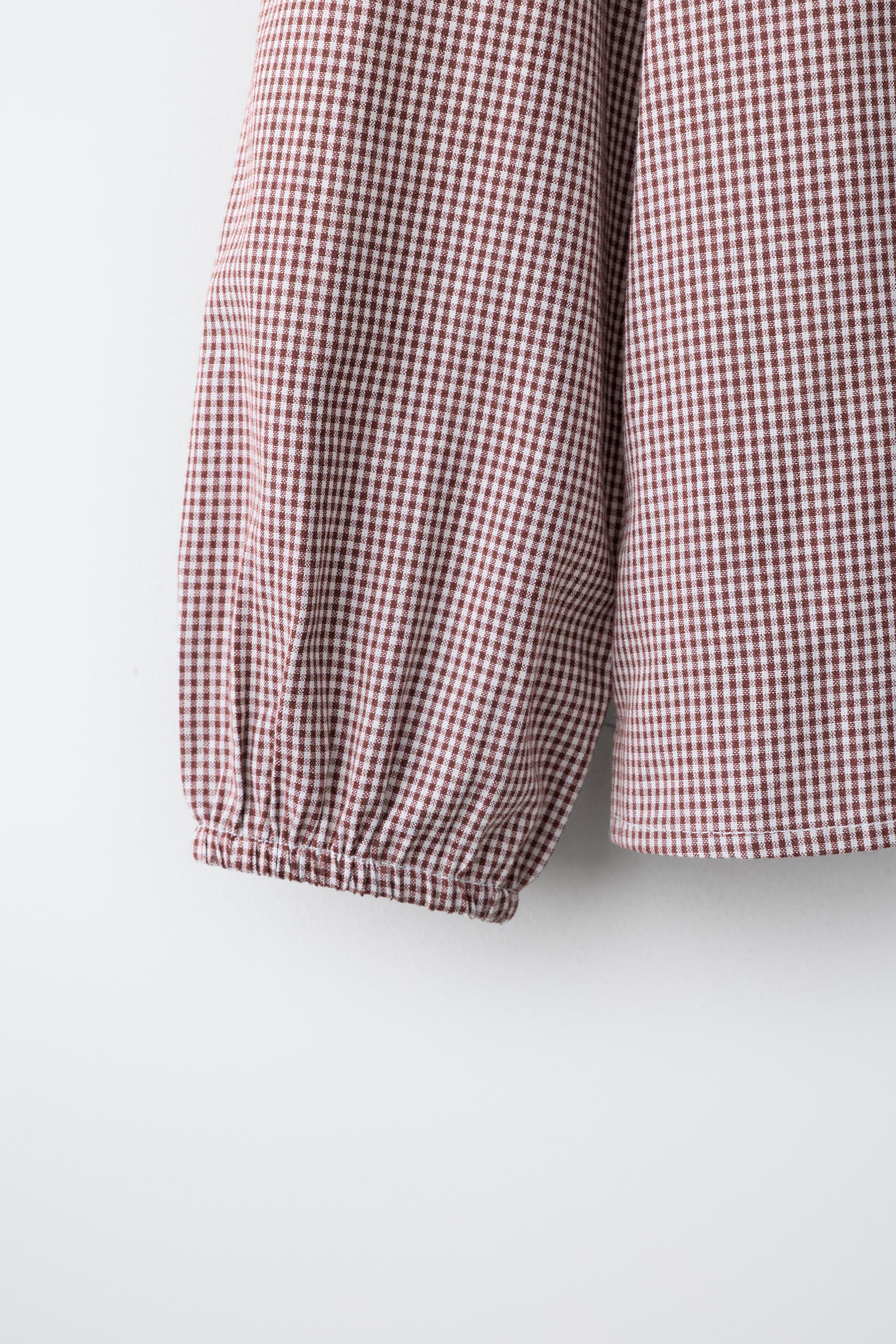 CHEMISE À CARREAUX ET SURPIQÛRES