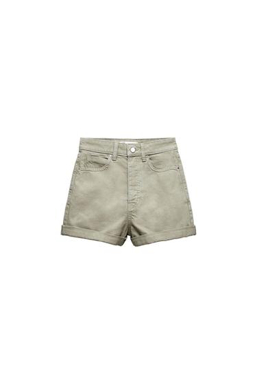 Light khaki green denim shorts with turn-ups, front pockets and metal button fastening on a white background.