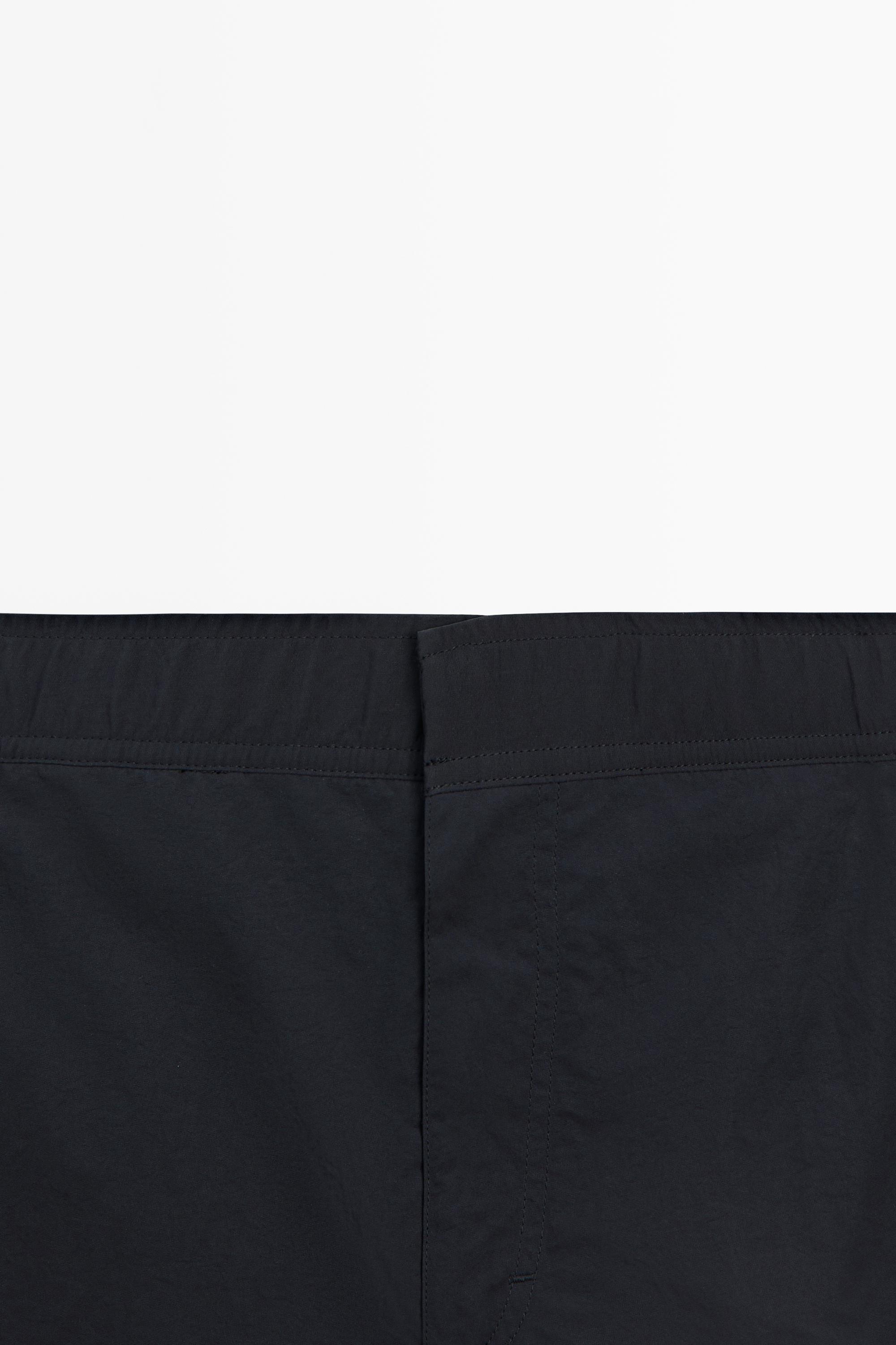 Plain swimming trunks with waist detail