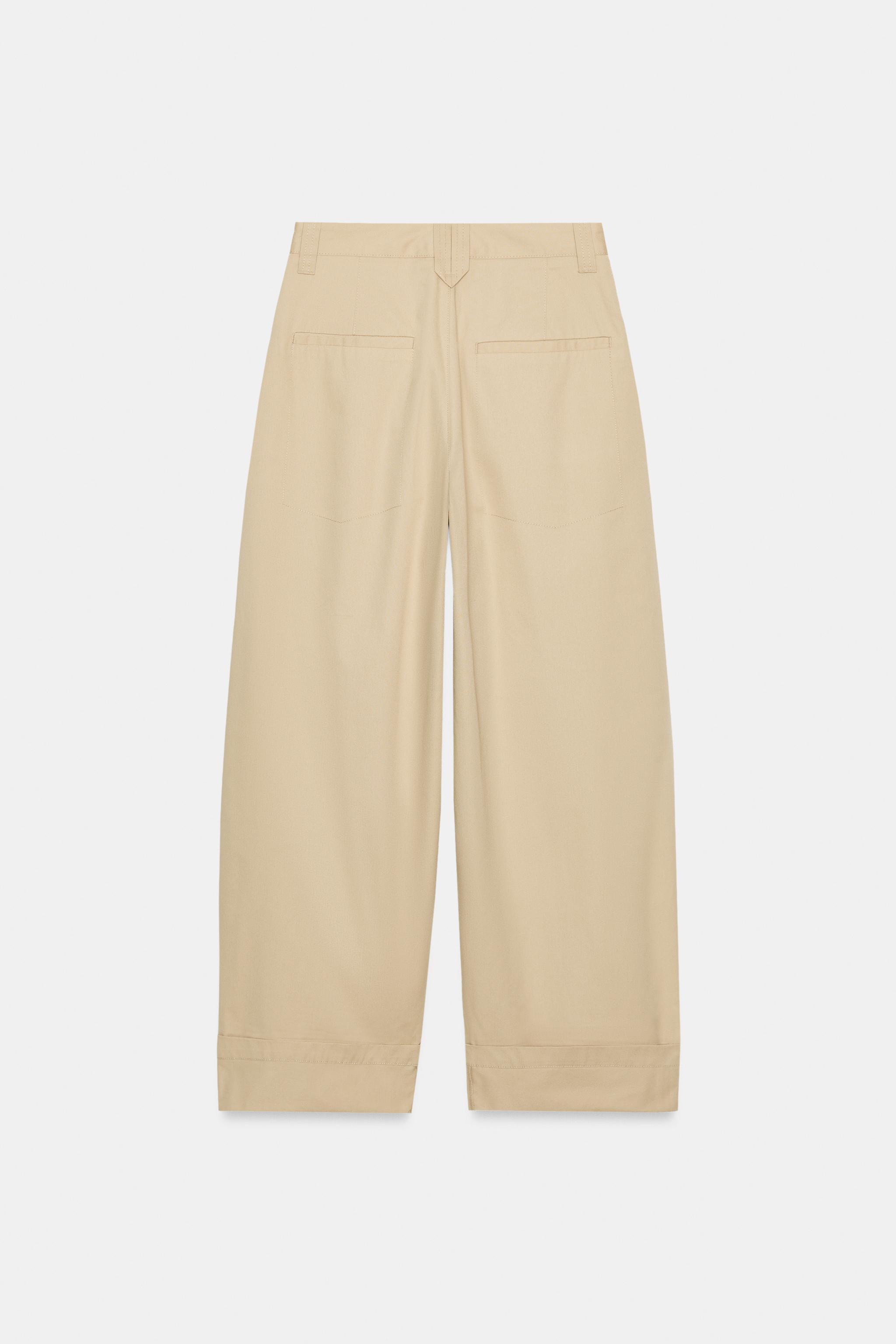 PANTALON À PINCES ET BAS REVERS