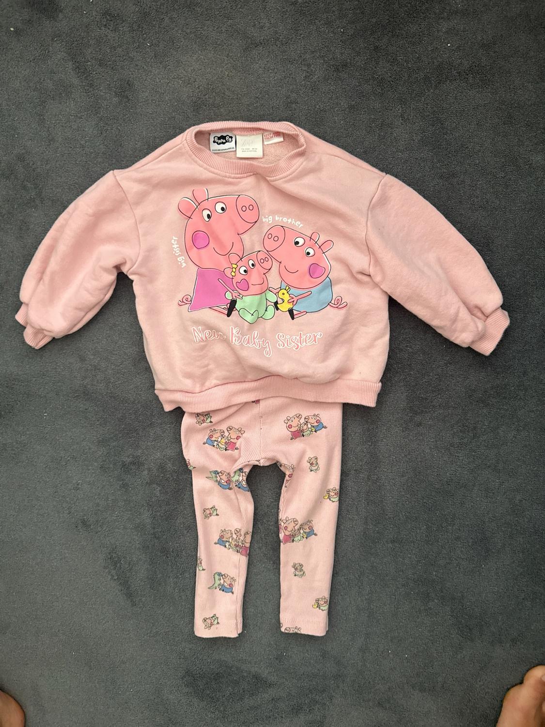 Pink Peppa Pig outfit on a grey background. Printed sweatshirt and pants. Text: "big sister", "big brother", "New Baby Sister".