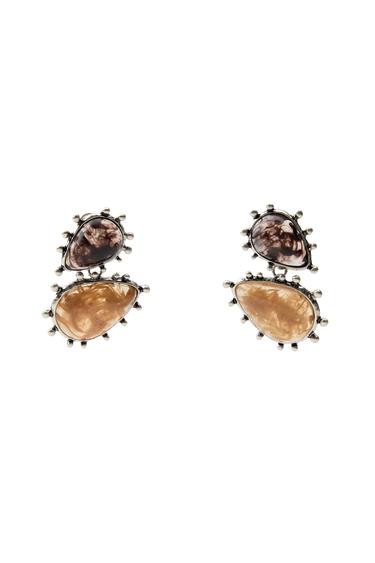 Front view of earrings with brown and beige stones on a black background.
