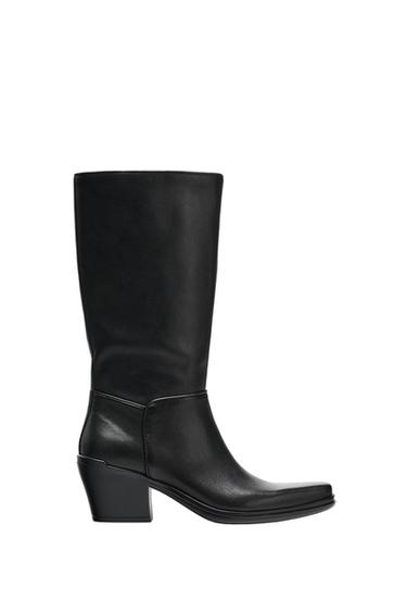 Black high-leg boot with a block heel and square toe, side view on a white background.
