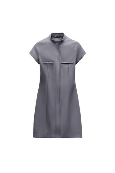 Front view of a gray dress with a high neck and front zip pockets.