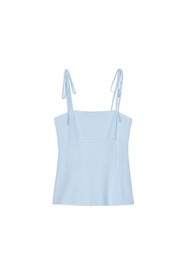 Front view of light blue top with adjustable straps.