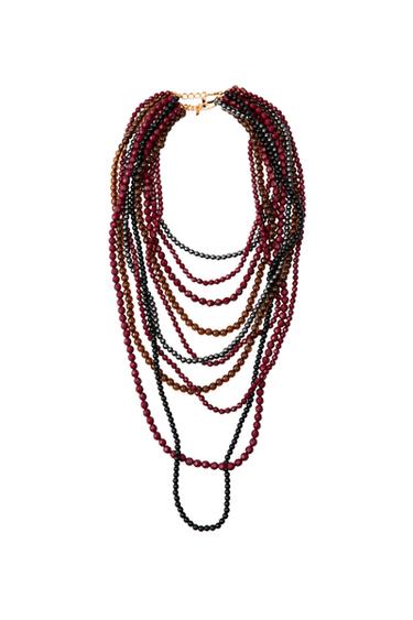 Multi-strand necklace with beads in brown, black, and burgundy tones.