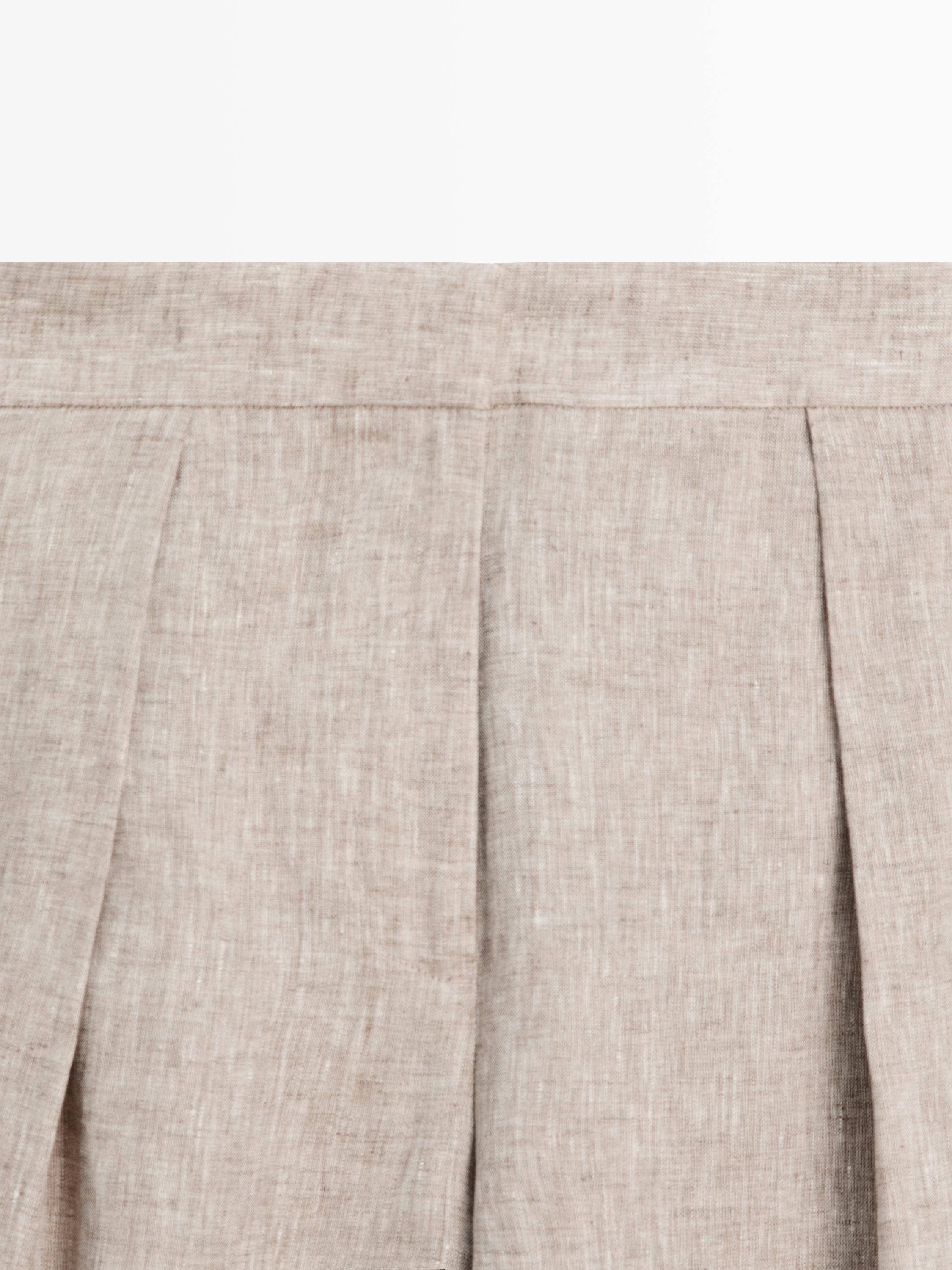 Suit trousers with buckle detail