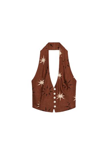 Front view of a sleeveless terracotta top with sun print, halter neck, V-neck, front buttons, and back buckle.