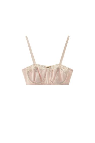 Front view of a dusty rose bralette with a straight neckline, thin straps, matching lace trim, and a contrasting floral appliqué on the chest.